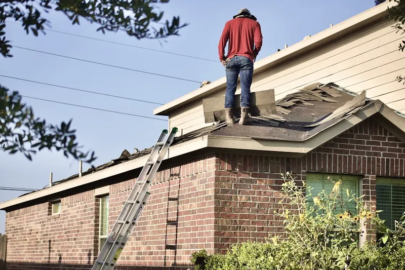 Professional roofer working on a residential roof in Shaw Mines